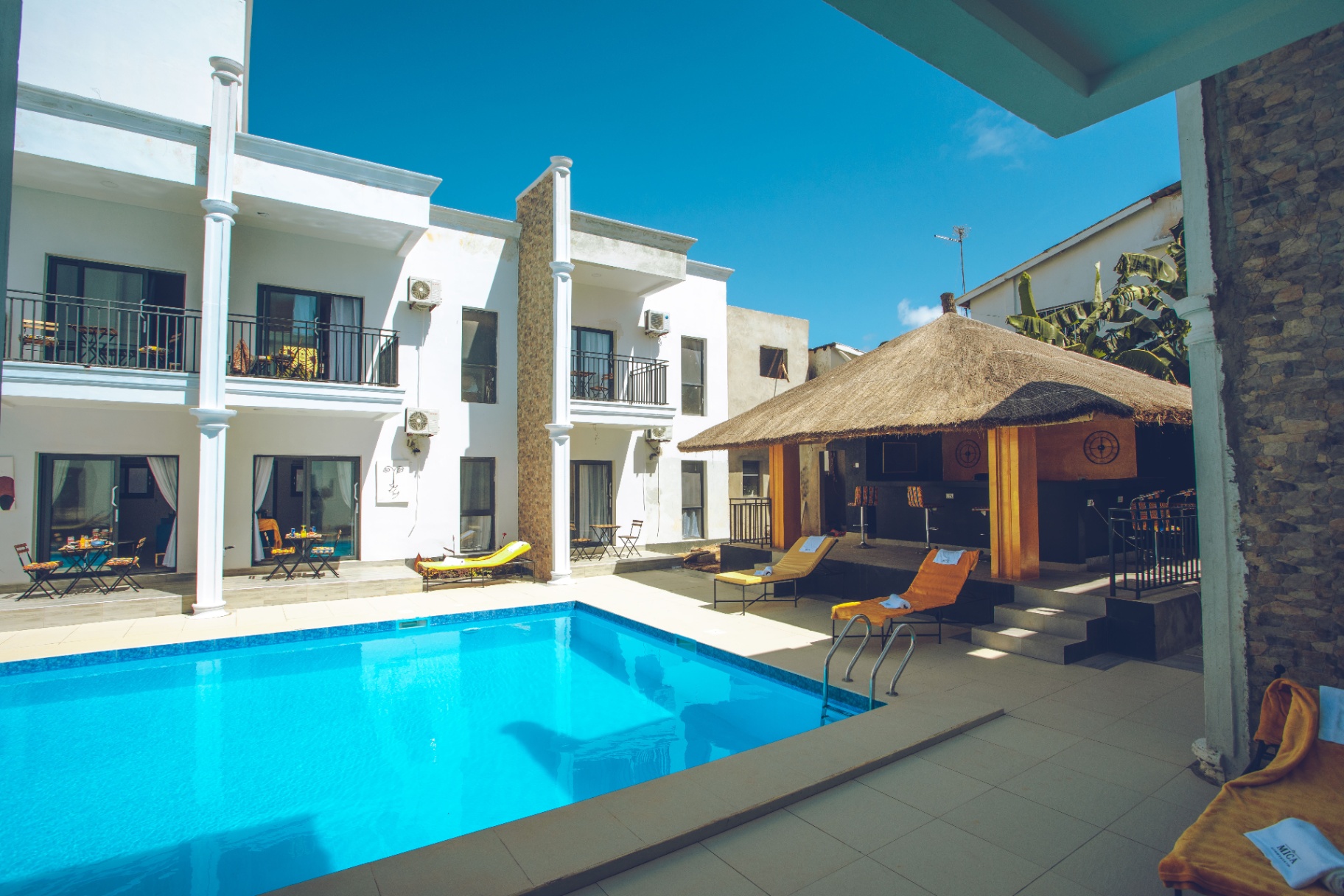 MICA Apartments pool with thatched outdoor bar