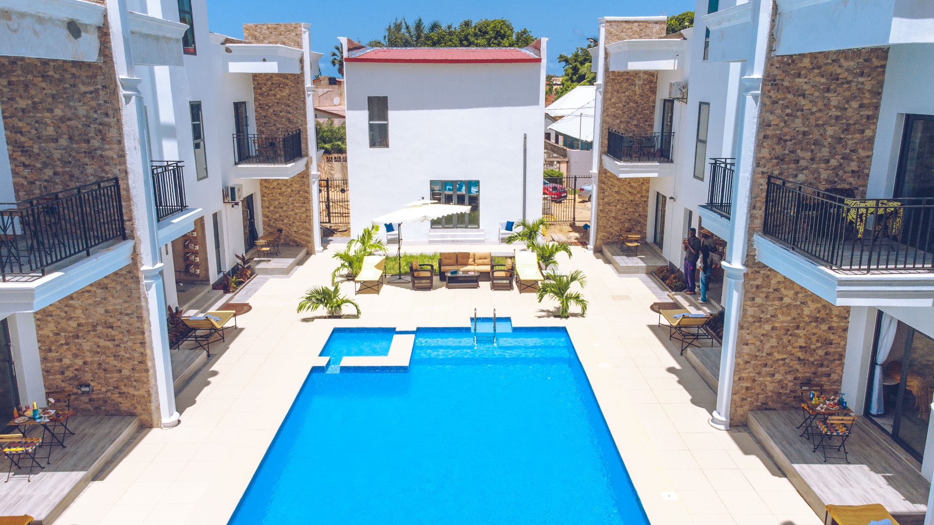 MICA Apartments courtyard lounge seating beside the pool